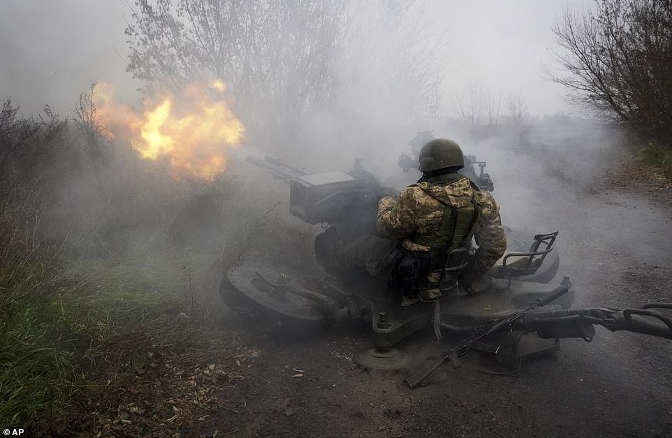 Ukrainian National guard soldiers fire at Russian positions from an anti-aircraft gun in the Kharkiv region