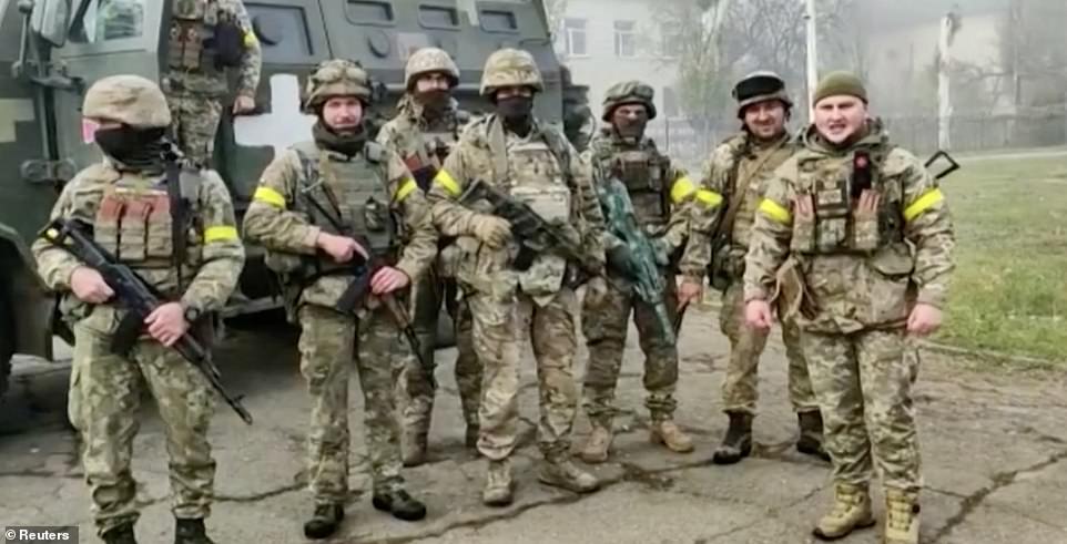 Kyiv's men are shown liberating the village of Snihurivka, around 30 miles north of Kherson, today after Russian forces began retreating from their positions back across the Dnipro River