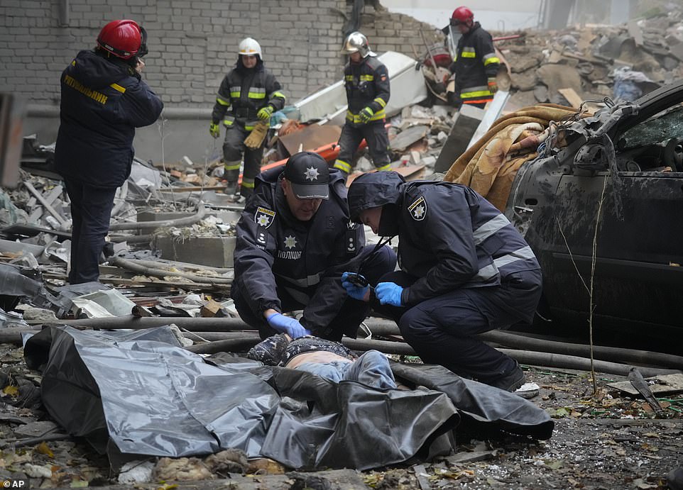 Police inspect a dead body at the scene of night shelling in Mykolaiv,