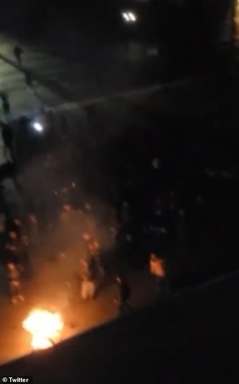 Pictured: Footage from a rooftop in Kherson shows a crowd in a town square singing Ukrainian songs in celebration